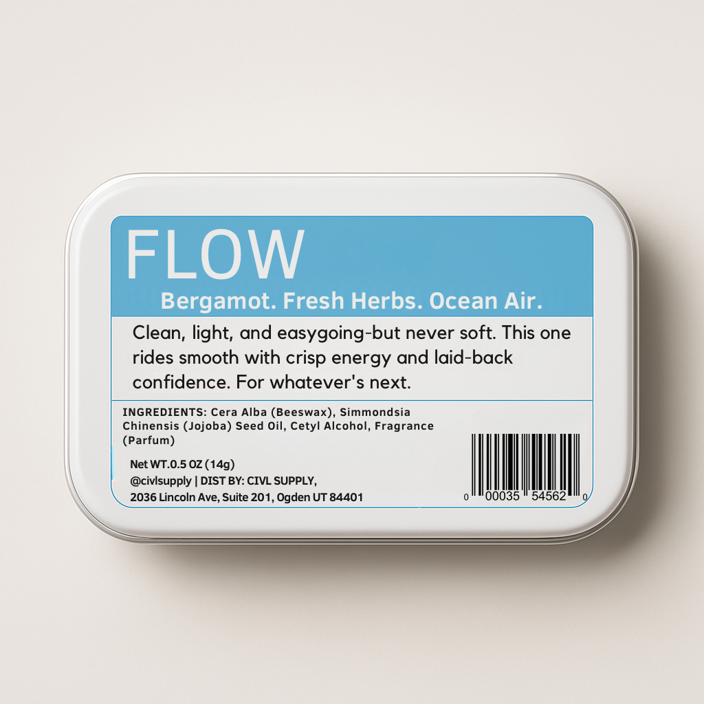 A small, rectangular tin container labeled 'FLOW Solid Cologne' made by civl supply with the text 'Bergamot. Fresh Herbs.