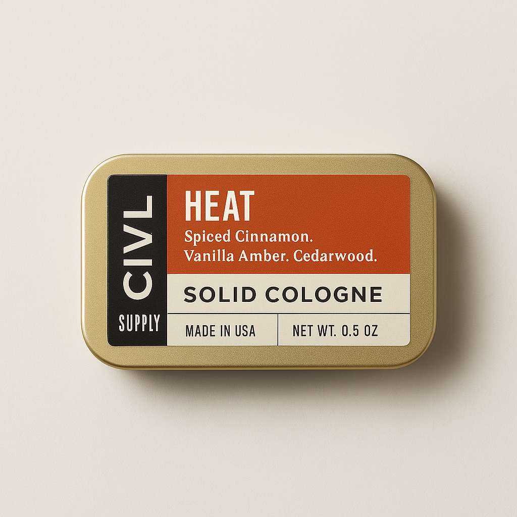 A tin container containing solid cologne labeled 'HEAT' by CIVL Supply with the description 'Spiced Cinnamon, Vanilla Amber, Cedarwood.'