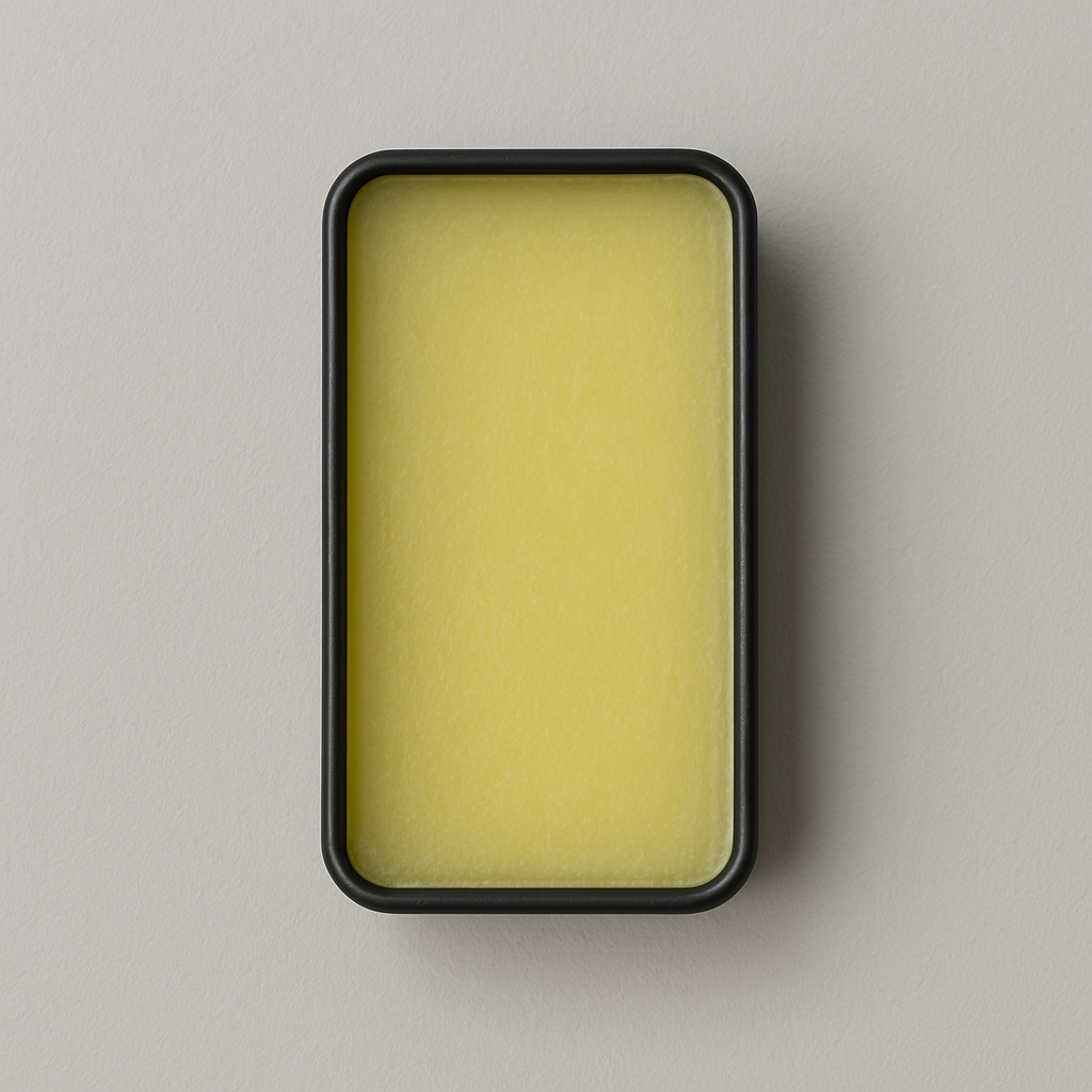 A small, rectangular tin container labeled 'ICON Solid Cologne' with the text 'Blackcurrant, Smoky Pineapple, Oakmoss