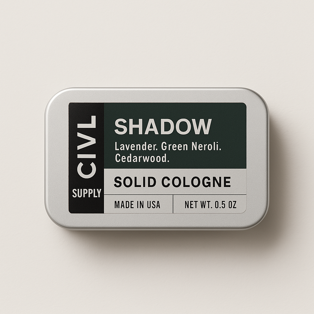 A small metal tin labeled 'SHADOW' containing solid cologne. The packaging is minimalistic with a green and black label, and the product is identified as 'CIVL Supply', 'Made in USA', with a net weight of 0.5 OZ