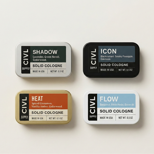 Four tins of Civil Supply solid cologne on a light background